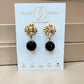Aretes de Ónix Negro Facetado con Base Margarita con Zirconia